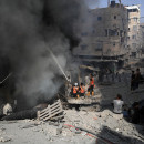 <p>Los bomberos se afanan por extinguir el fuego tras un bombardeo en Gaza. /<strong> Mohammed Zannoun</strong></p>