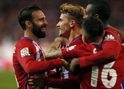 <p>Griezmann (centro) es felicitado por sus compañeros tras anotar el gol del triunfo ante el Sporting de Gijón (1-0)</p>