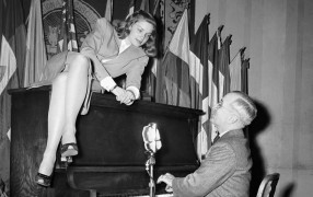 <p>La actriz Lauren Bacall, subida sobre el piano que tocaba el entonces vicepresidente del Gobierno norteamericano, Harry S. Truman. </p>
