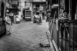 <p>Una mujer realiza trabajos domésticos en una calle de Italia. </p>